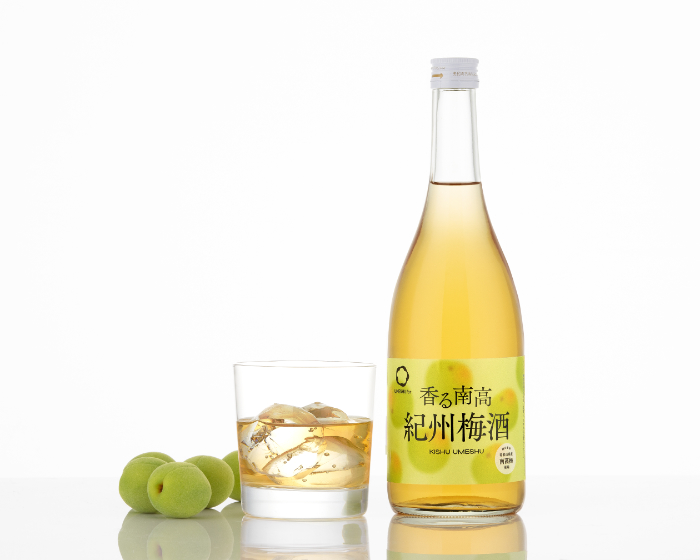 umeshu bottle with glass and plums